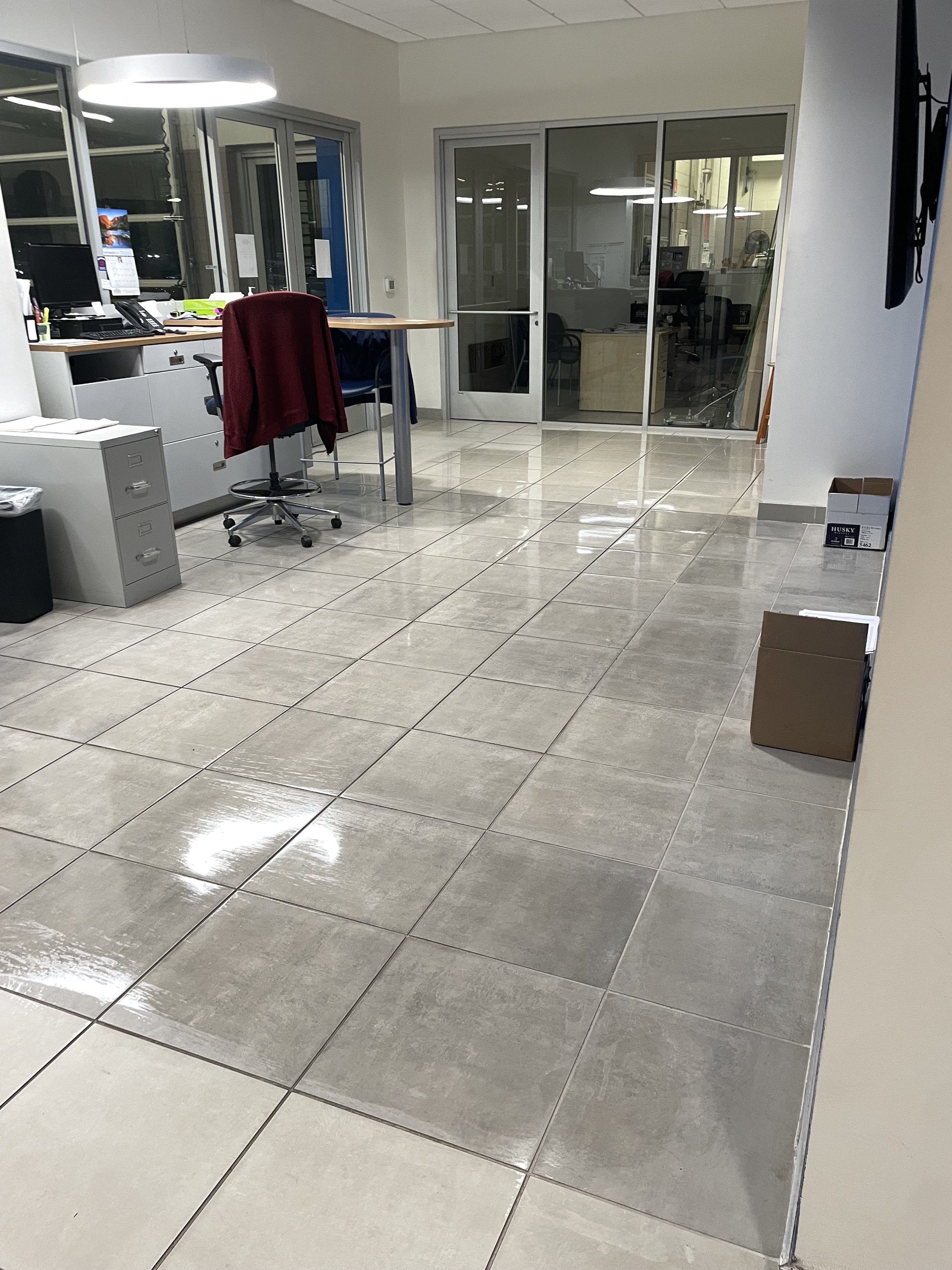 Floor care specialist finishing commercial VCT floor stripping and polymer wax application